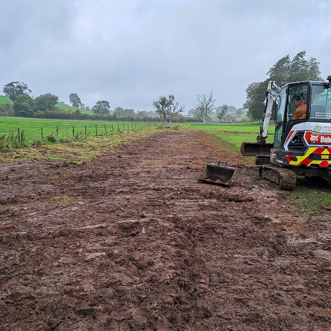 A digger is returfing the old, filled-in channel with native species-rich seeded turf.