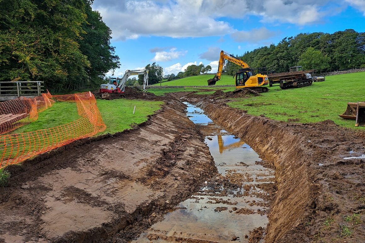 Digger creating a new river channel to 'rewiggle' the route and slow the flow of water through the channel.