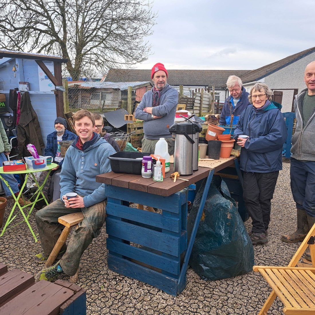 A large group of volunteers assembled for a picture during their tea break at the Penrith community tree nursery.