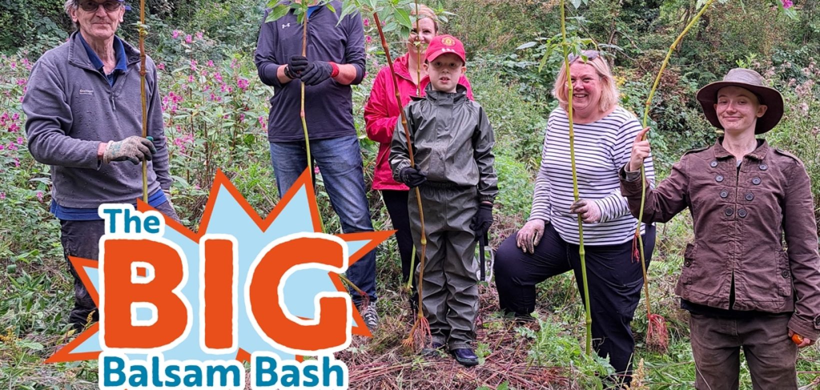 Image of volunteers holding uprooted Himalayan balsam plants with a logo in the corner which reads: 