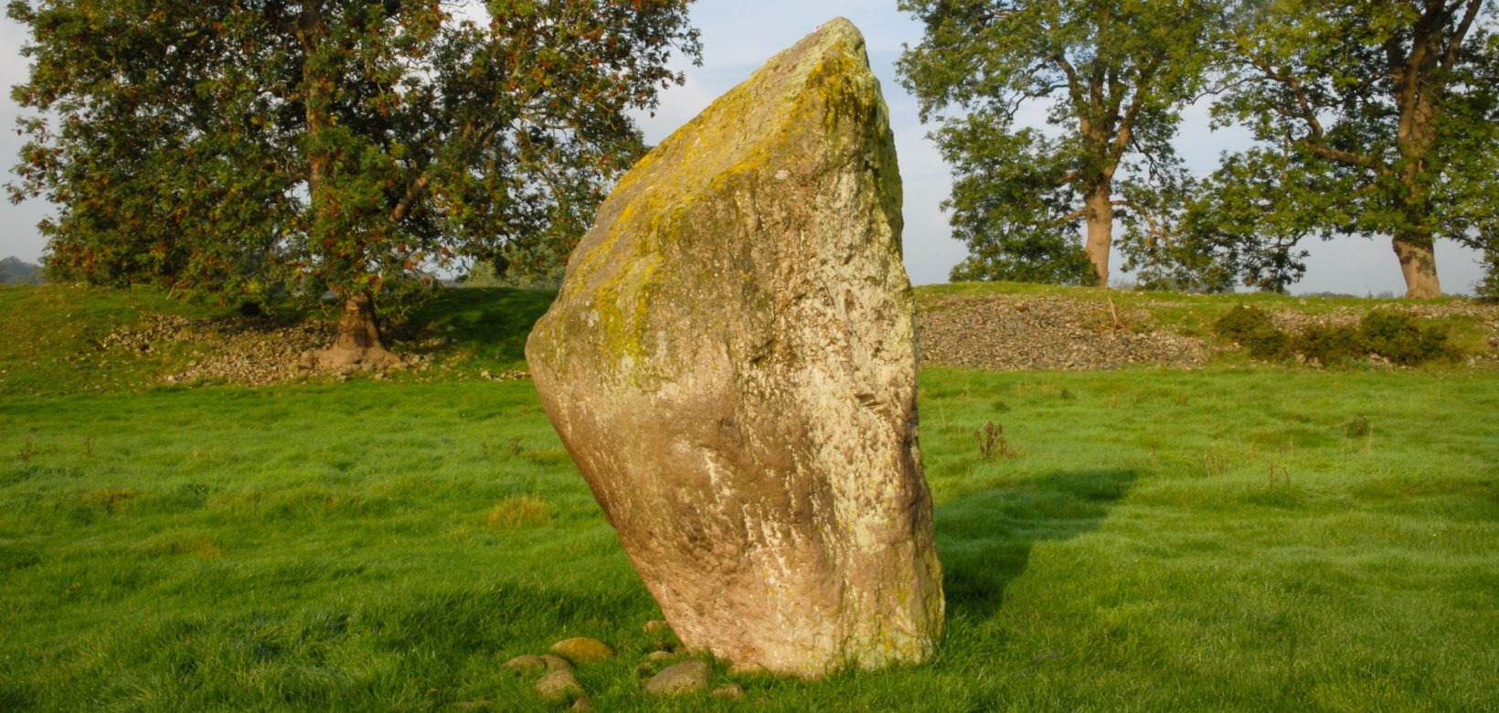 Mayburgh Henge - a tooth-shaped stone standing on its own in a field.