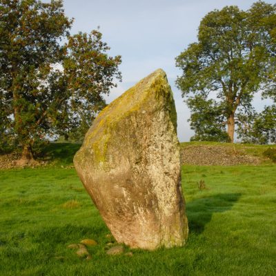Mayburgh Henge - a tooth-shaped stone standing on its own in a field.