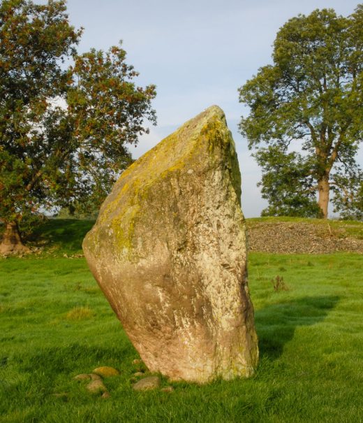 Mayburgh Henge - a tooth-shaped stone standing on its own in a field.