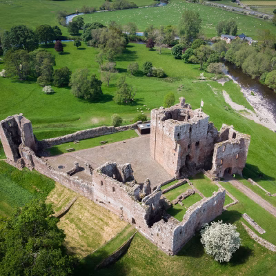 Aerial view of Brougham Castle and surrounding fields.