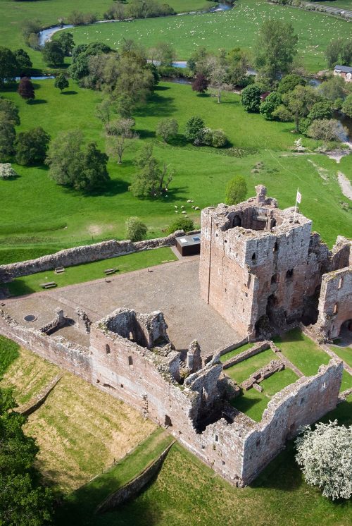 Aerial view of Brougham Castle and surrounding fields.