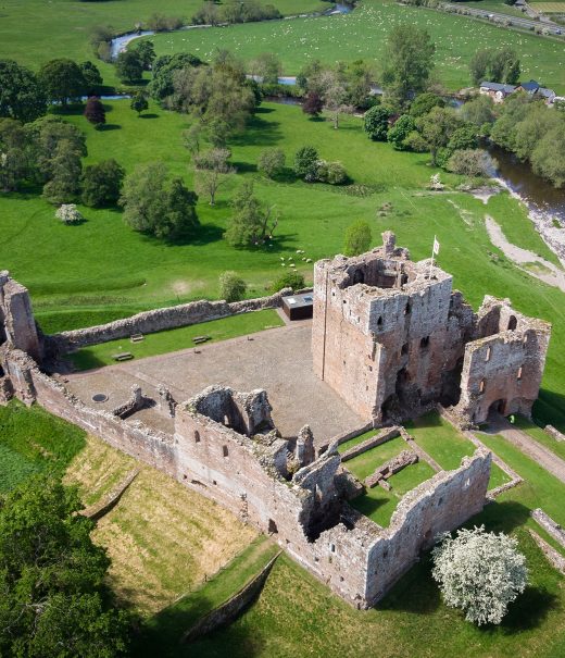 Aerial view of Brougham Castle and surrounding fields.