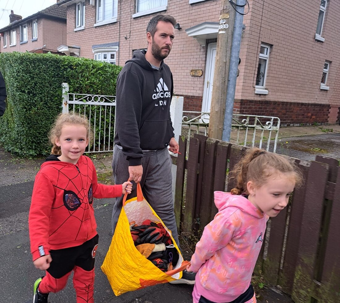 A family of volunteers setting off from home with cake and equipment in a bag to tackle Himalayan balsam at Petteril Vale, Carlisle.