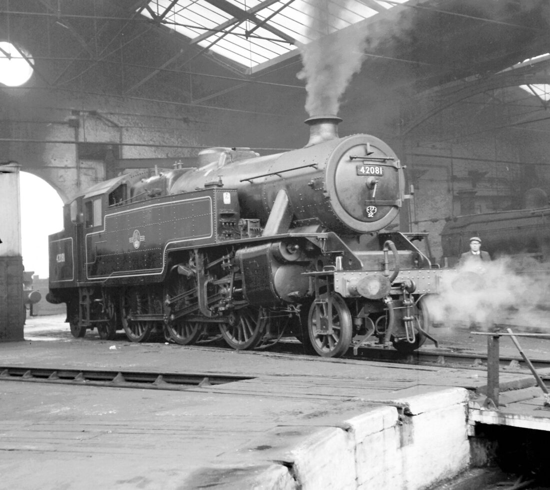 Steam engine sat on turntable inside train engine shed at Engine Lonning.