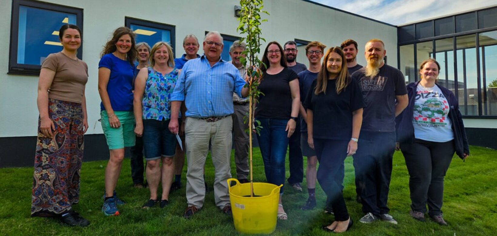 Group photograph of ERT staff and outgoing Chairperson Charles Ecroyd taken in front of ERT offices in Penrith.