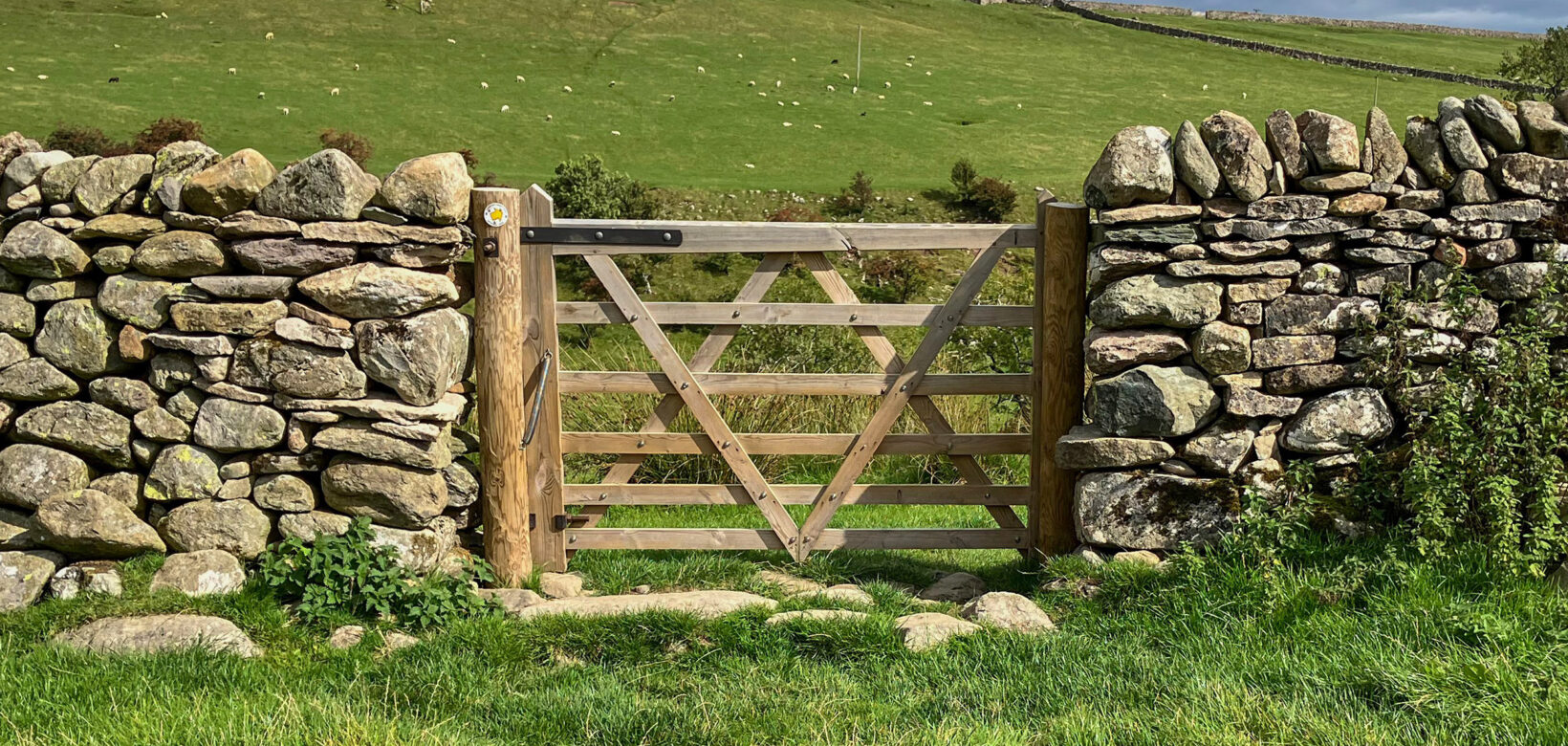 Closed gate within a dry stone wall