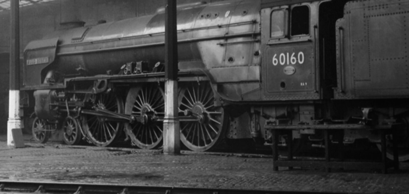 A large steam engine sat within an engine shed at Engine Lonning. Former site of a substantial train engine yard.