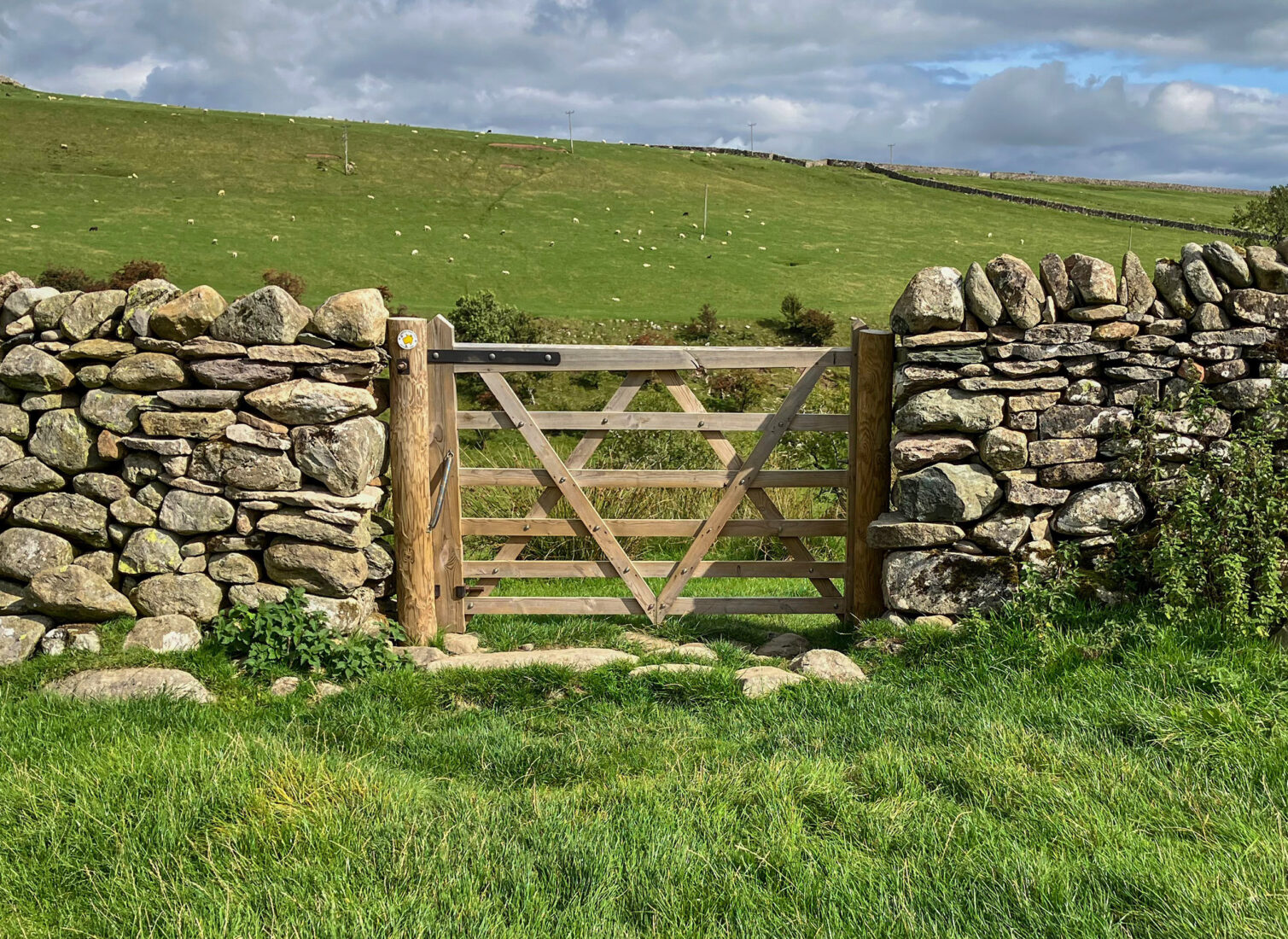 Closed gate within a dry stone wall