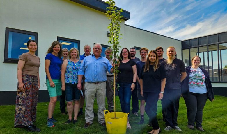 Group photograph of ERT staff and outgoing Chairperson Charles Ecroyd taken in front of ERT offices in Penrith.