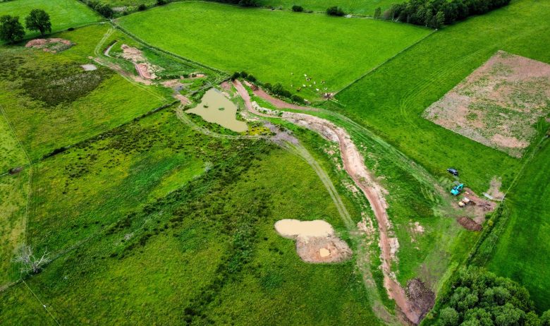 Aerial view of groundworks creating a new wiggly river channel and scrapes.