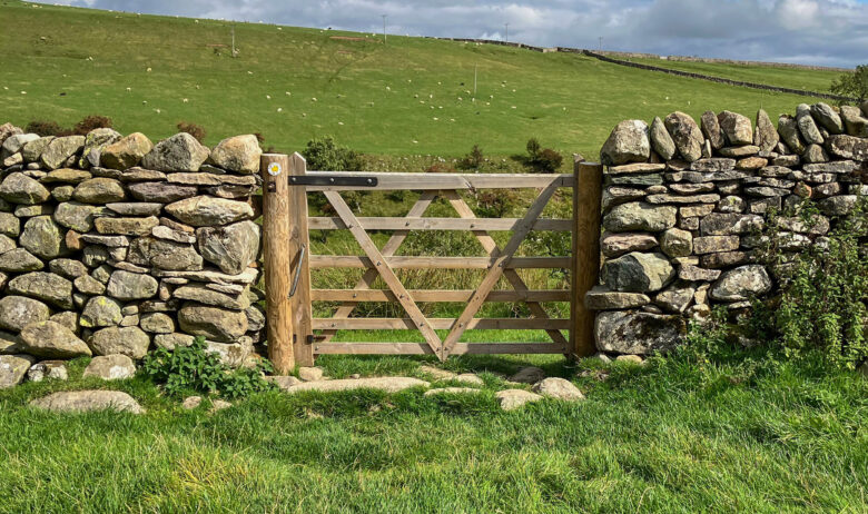 Closed gate within a dry stone wall