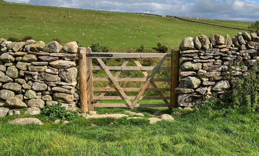 Closed gate within a dry stone wall