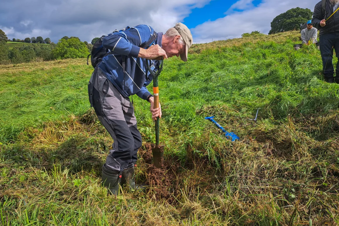 ERT volunteer digging with spade onsite at Wallacefield.