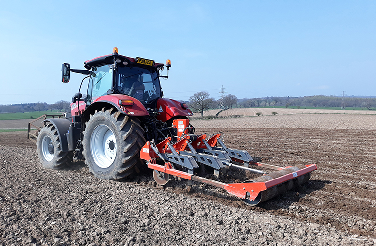 Farm machinery ploughing land
